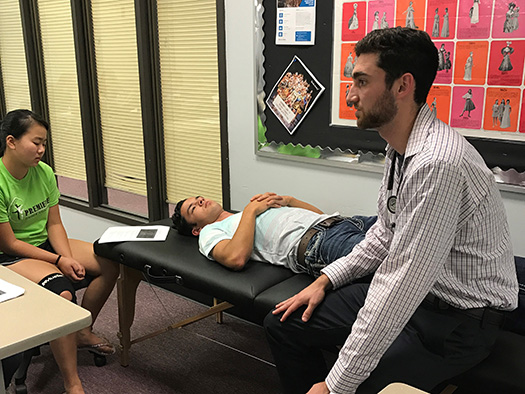 medical student examining a patient