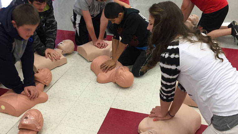 students practicing cpr